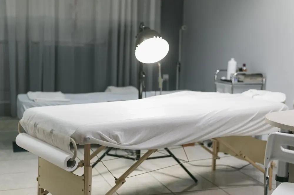 Procedure room with a treatment bed and examination lamp