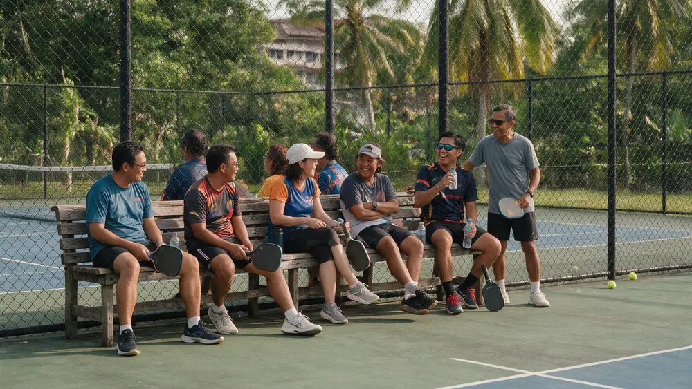 Members resting courtside after a Sunday session